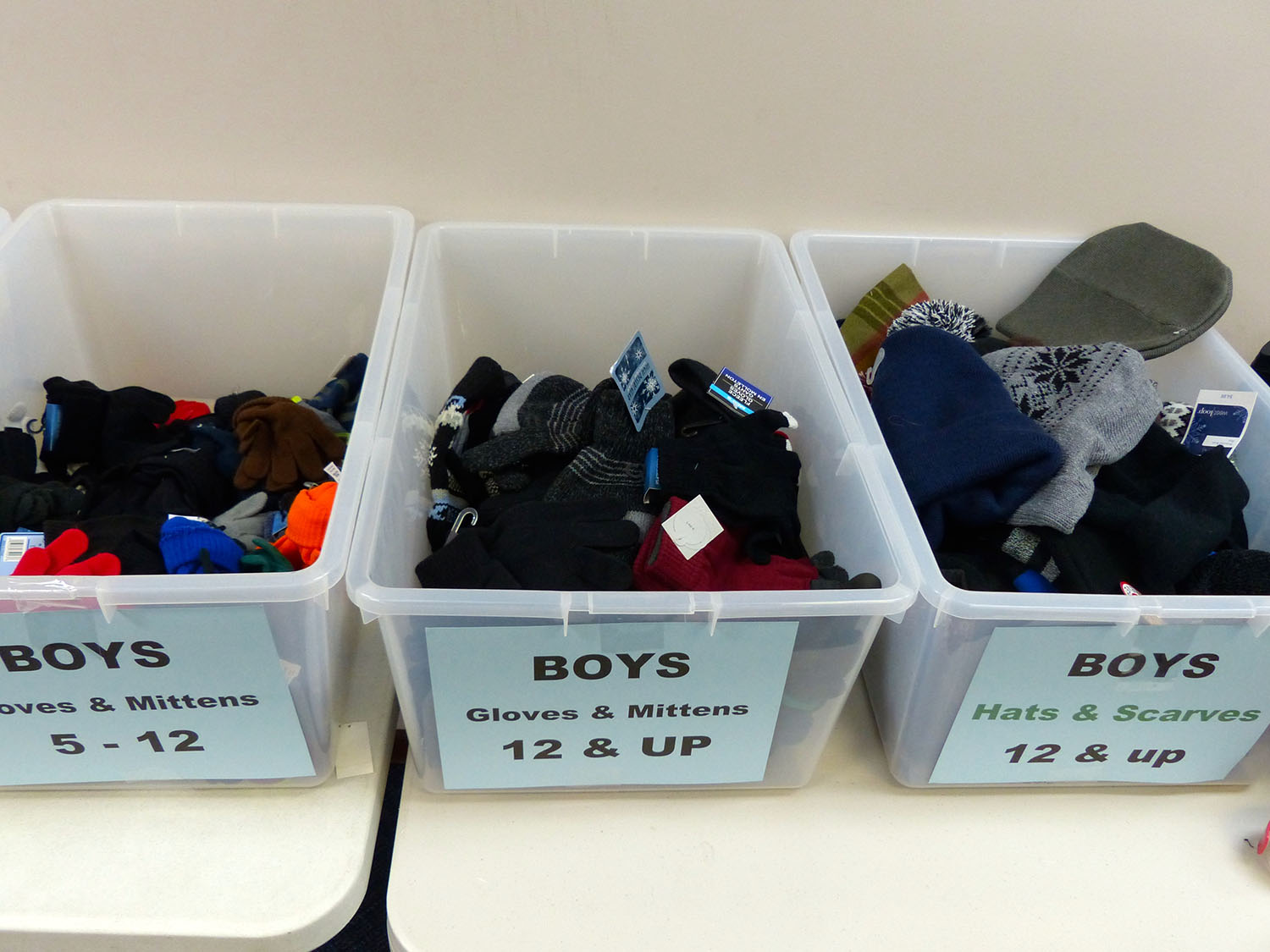 Bins of donated hats, scarves and mittens, right, are also given to children. Fox Valley Labor News file photos